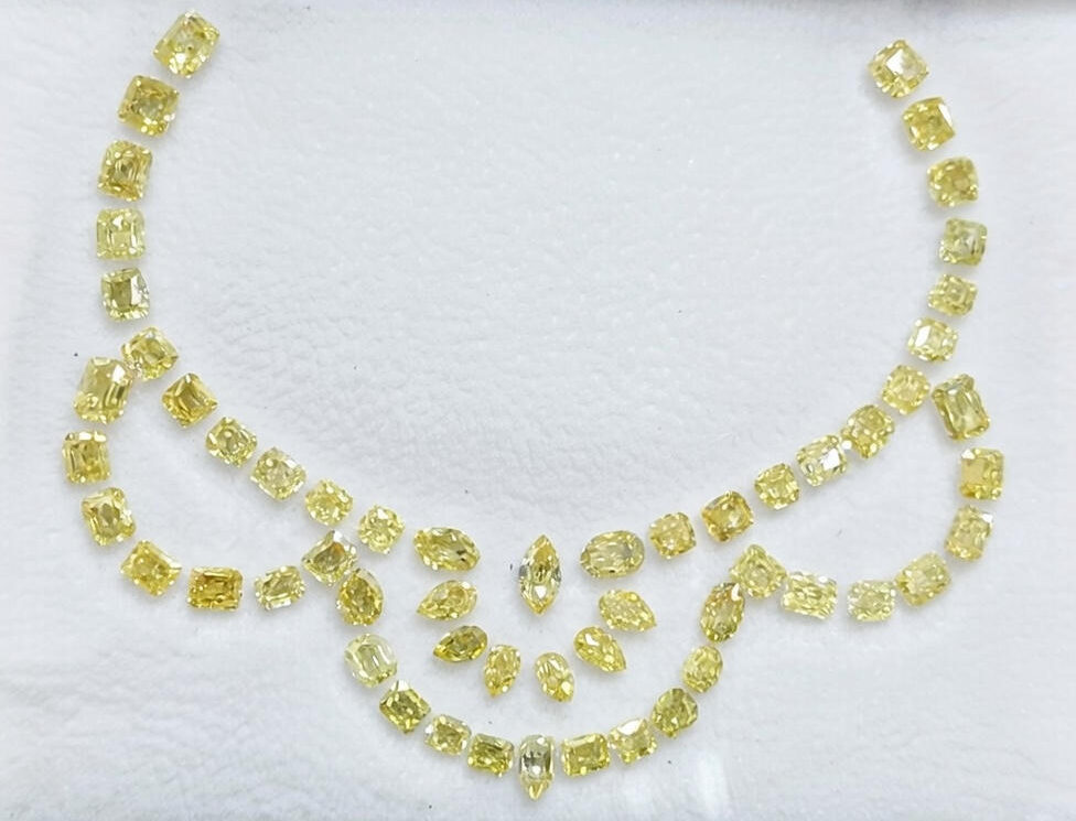 Fancy Yellow Cushion And Pear Diamonds arranged in a necklace layout