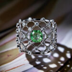 Natural green diamond ring with lattice white gold design on hand